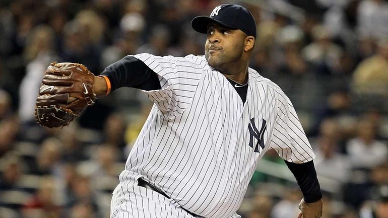 CC Sabathia #52 of the New York Yankees pitches in...