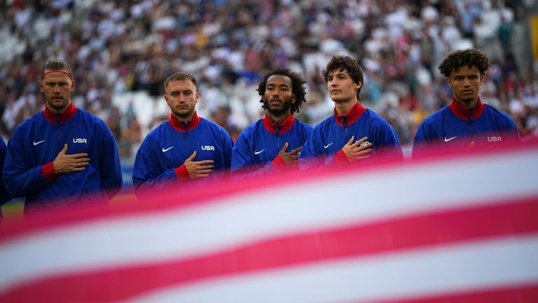 The United States men's soccer team sings the national anthem...