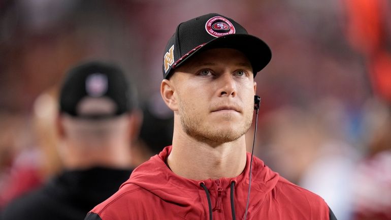 San Francisco 49ers running back Christian McCaffrey walks on the...