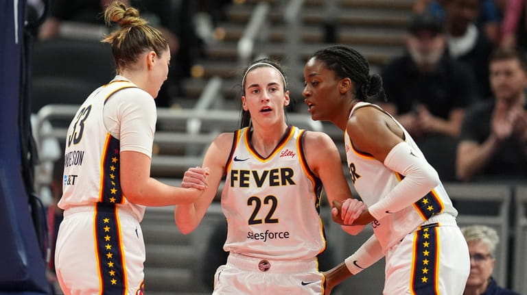 Indiana Fever guard Caitlin Clark (22) is helped to her...