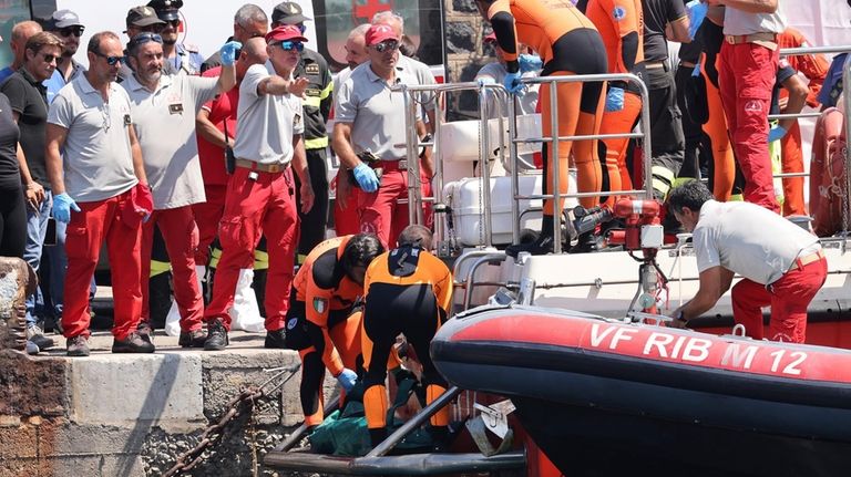 Italian firefighter divers bring ashore in a plastic bag the...