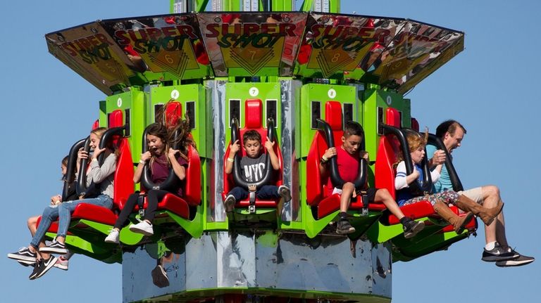 Festivalgoers react to the sudden freefall provided by the Super...