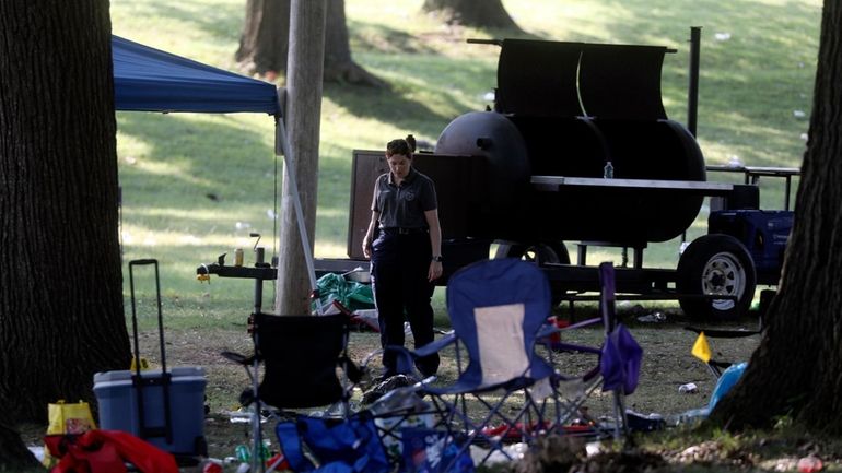 Rochester police technicians walk through the crime scene in Maplewood...