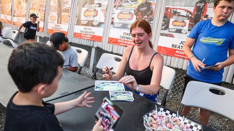 Tomaszewski hands one of her signed cards to Timmy Ryan,...