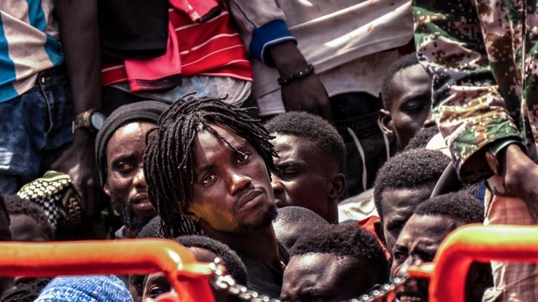 Migrants disembark at the port of on "La Estaca" in...