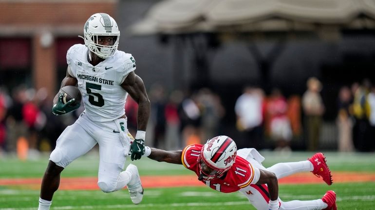 Michigan State Spartans running back Nate Carter (5) advances past...