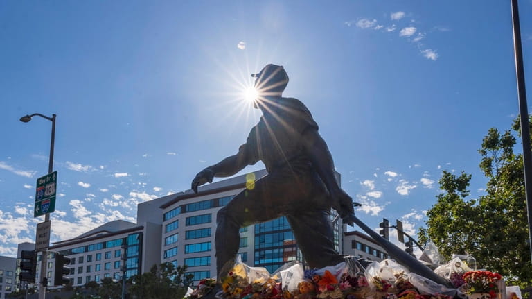 Items have been left at a statue of Willie Mays,...