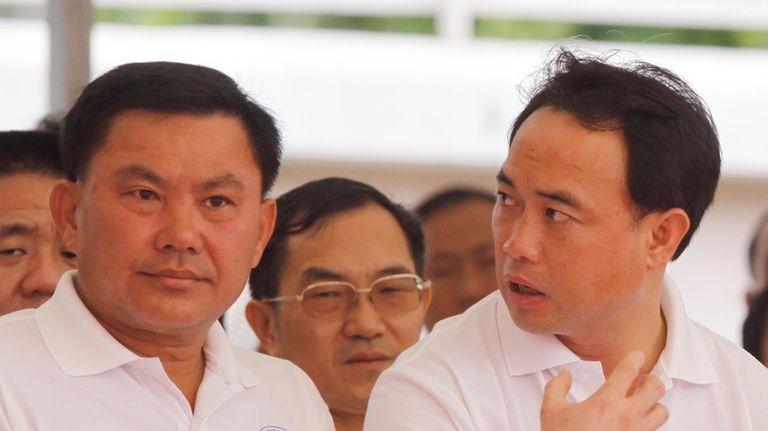 Cambodian business tycoons, Ly Yong Phat, front left, takes part...