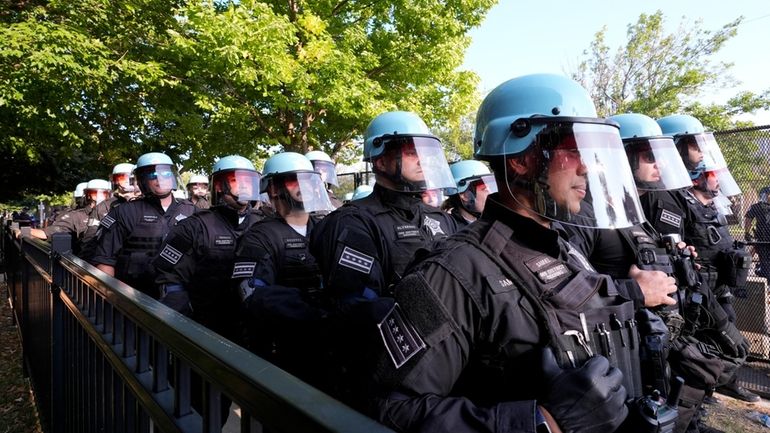 Police line up after a piece of fence was knocked...