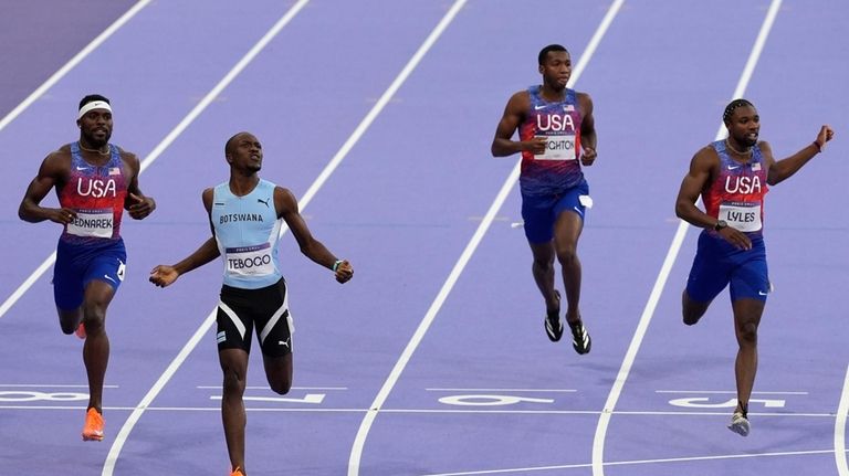 Letsile Tebogo, of Botswana, second left, wins the men's 200-meters...