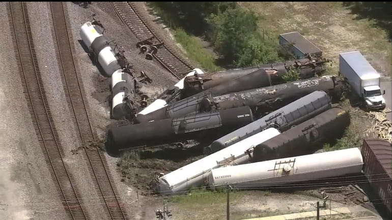 Train cars are piled up after a derailment on Thursday,...
