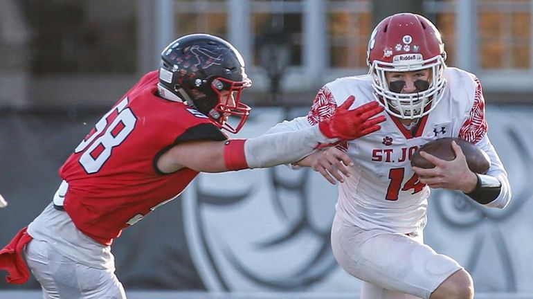 Maxwell Bowers of St. John the Baptist carries the ball...