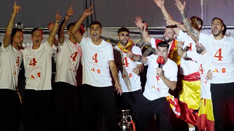 Spain's team captain Alvaro Morata, with the microphone, introduces player...