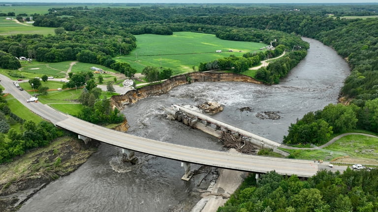 Floodwater continues to carve a channel around the Rapidan Dam,...