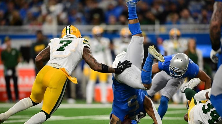 Detroit Lions running back David Montgomery (5) flips in front...