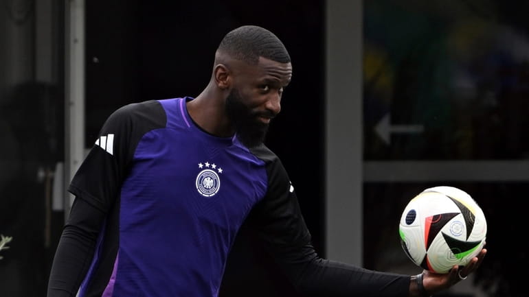 Germany's Antonio Rüdiger holds a ball during the last training...