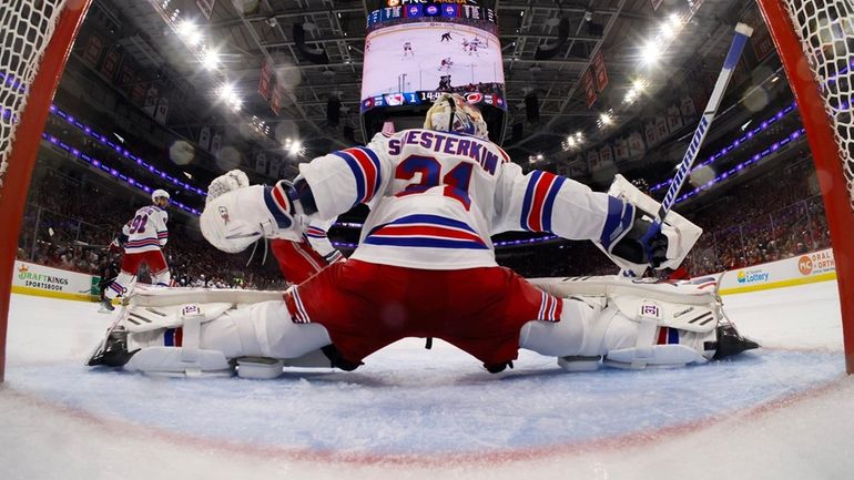 Igor Shesterkin of the New York Rangers guards his net...