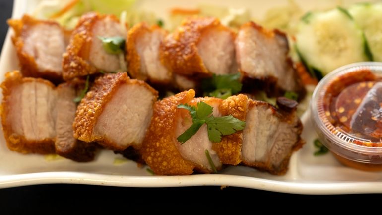 Crispy Pork Belly is presented at "Love & Thai" restaurant...