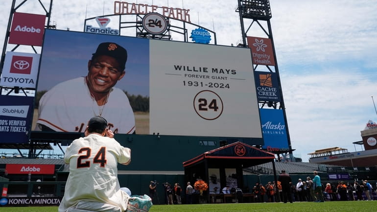 People attend a tribute for Willie Mays on Thursday at the...