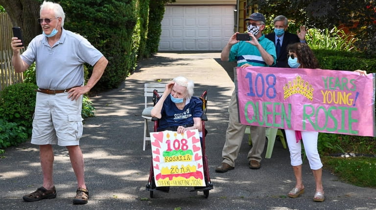 Rosalia Zona, who turned 108, watches a birthday parade held...