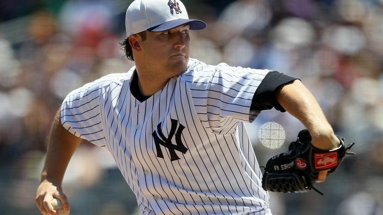 Phil Hughes delivers a pitch against the Toronto Blue Jays,...