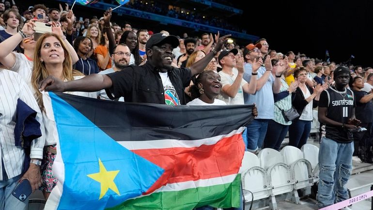 Fans are seen during a delay in the South Sudan...