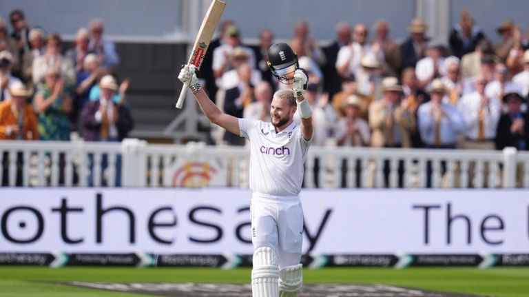 England's Gus Atkinson celebrates his century during during day two...