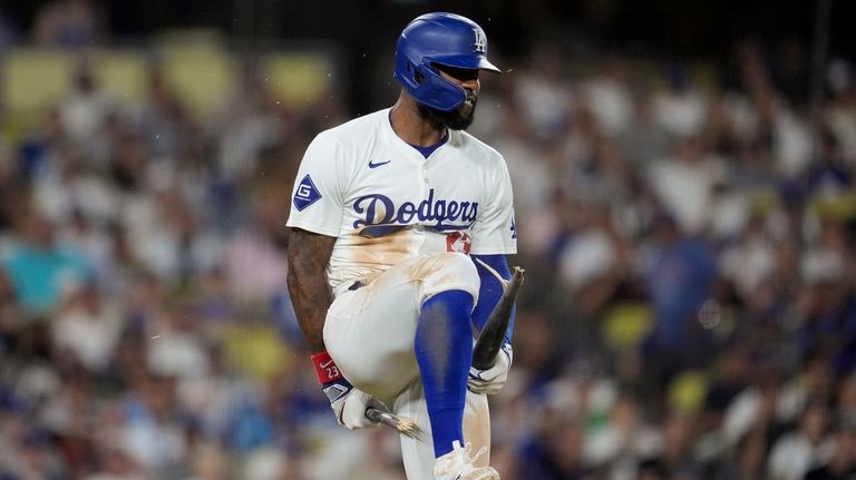 Los Angeles Dodgers' Jason Heyward breaks his bat over his...