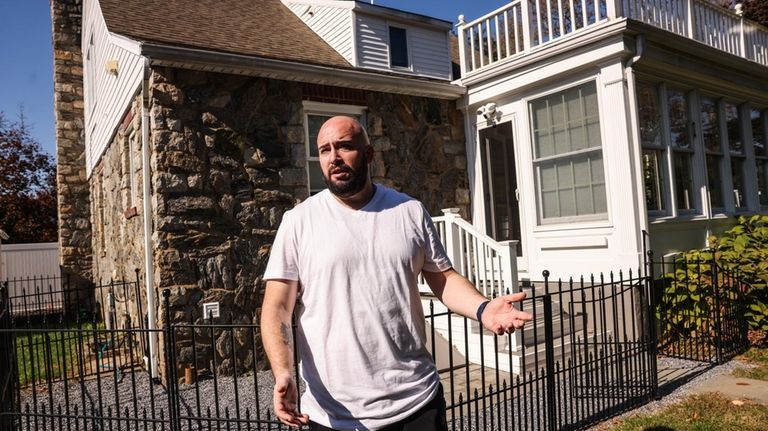 Michael Wosczyk outside the home he and his family recently purchased...