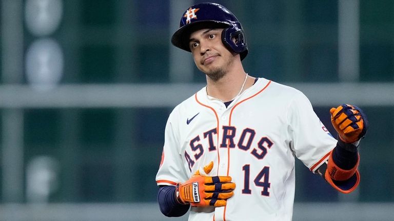 Houston Astros' Mauricio Dubón celebrates after hitting a two-run single...