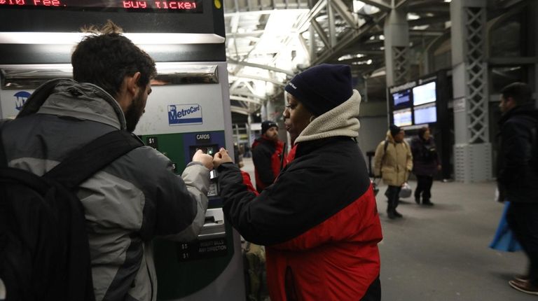 LIRR Care ambassador Stariasia Young, a Harlem resident, helps a customer...