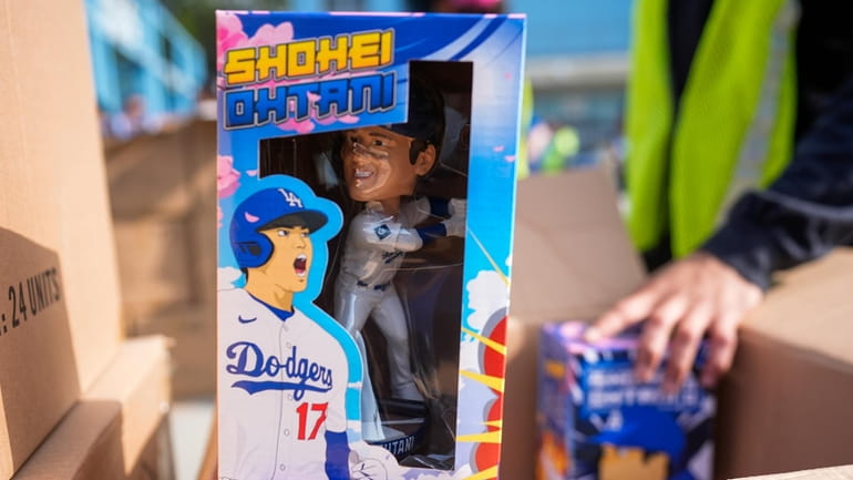 Bobbleheads of Los Angeles Dodgers designated hitter Shohei Ohtani are...