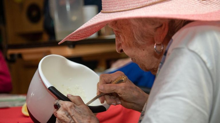 Theresa Ardezzone, 94, makes a dip from the fresh chives grown...