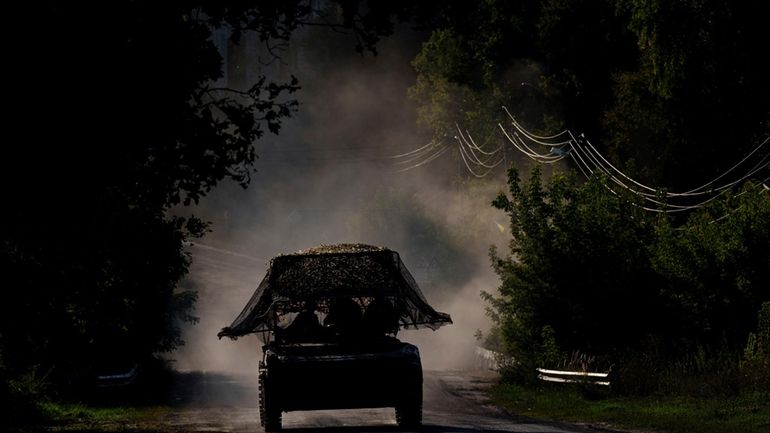 A Ukrainian armoured military vehicle travels near the Russian-Ukrainian border,...