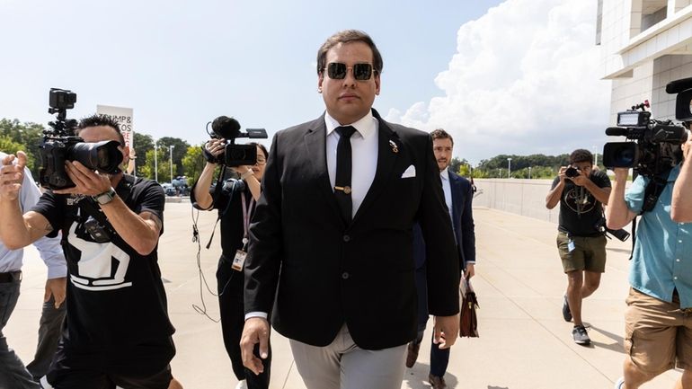 Former U.S. Rep. George Santos arrives at court in Central...