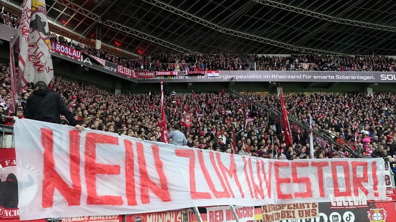 Bayern supporters protest with a banner reading "No to investors!"...