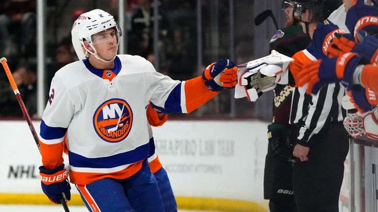 Islanders defenseman Mike Reilly, left, celebrates after his goal against...