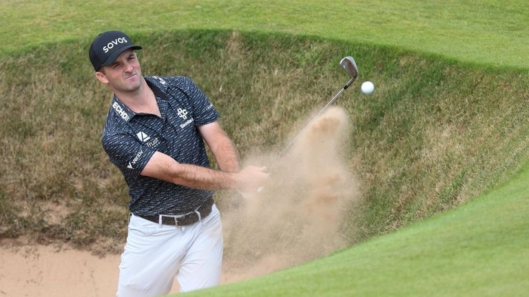 Denny McCarthy of the United States plays from a bunker...