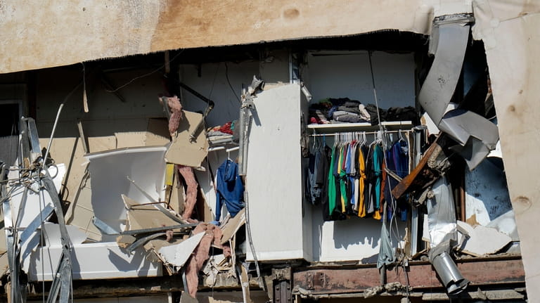 Clothing hanging in an apartment building that partially collapsed on...