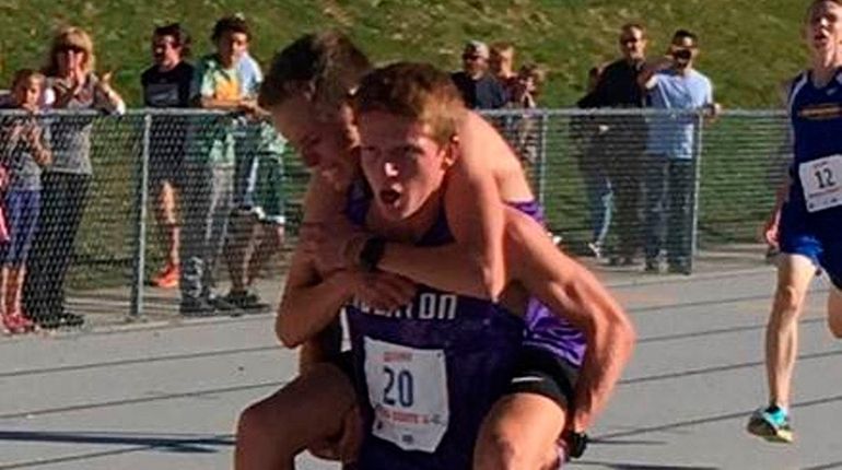 Sean Rausch carries teammate Blake Lewis, both runners on Bingham...