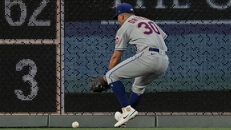 Mets centerfielder Rafael Ortega chases after a double hit by...