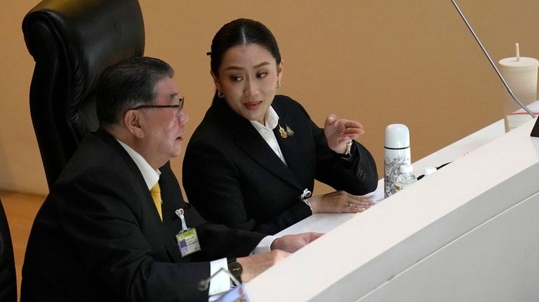 Thailand’s Deputy Prime Minister Phumtham Wechayachai, left, talks to Thailand's...