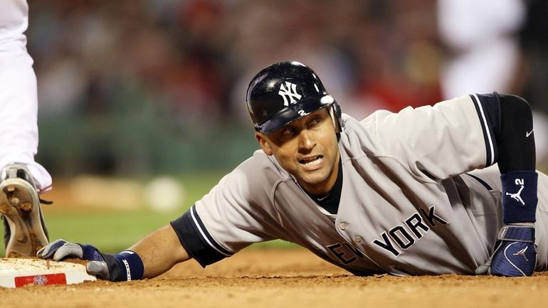 The Yankees' Derek Jeter is nearly picked off at first...