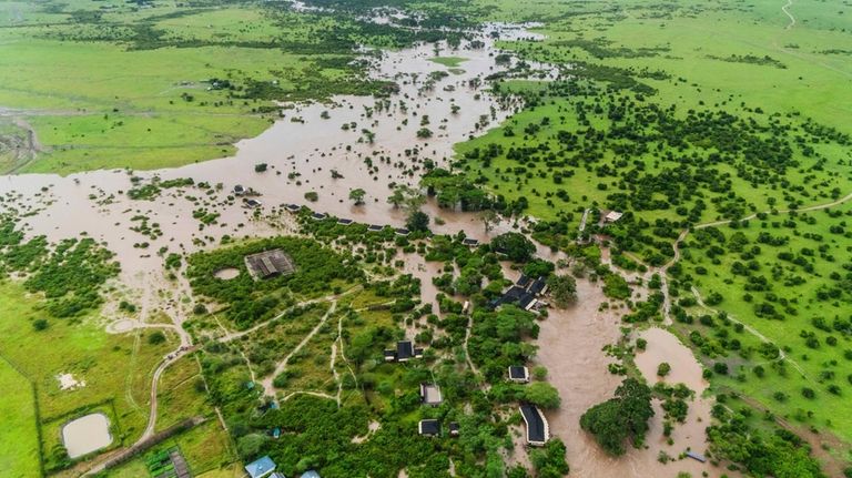 Aerial view of flooded Maasai Mara National Reserve, that left...