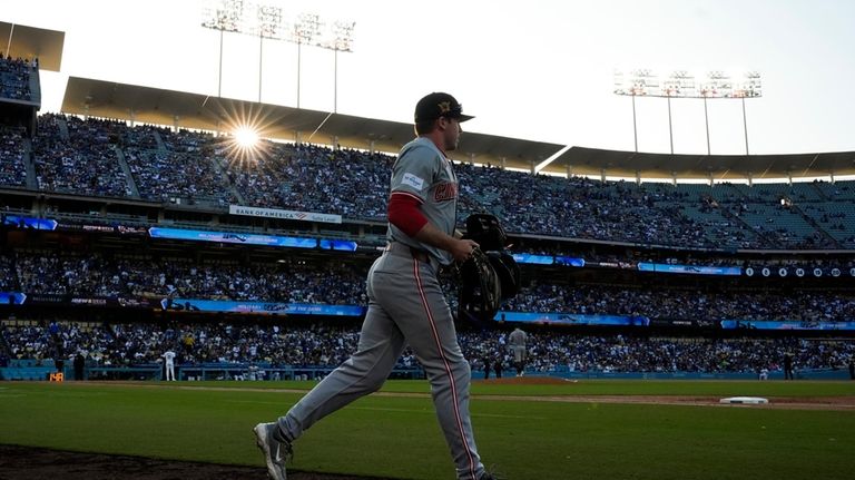 Cincinnati Reds left fielder Jacob Hurtubise (26) takes the field...