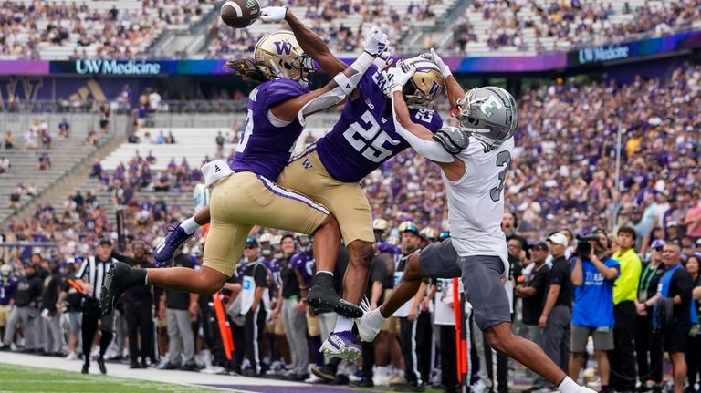 Washington safety Kamren Fabiculanan (13) and cornerback Elijah Jackson (25)...