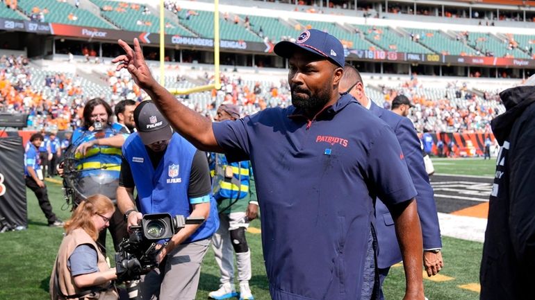 New England Patriots head coach Jerod Mayo walks off the...