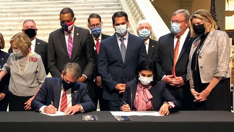 Georgia Gov. Brian Kemp, left, and Centers for Medicare and...