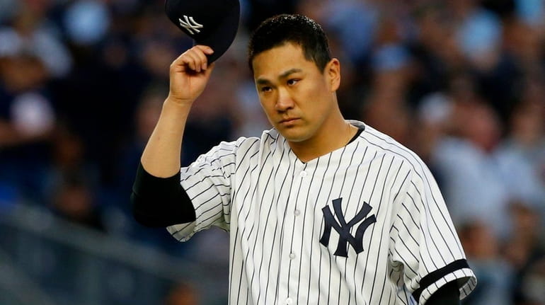 Masahiro Tanaka of the Yankees walks to the dugout during...