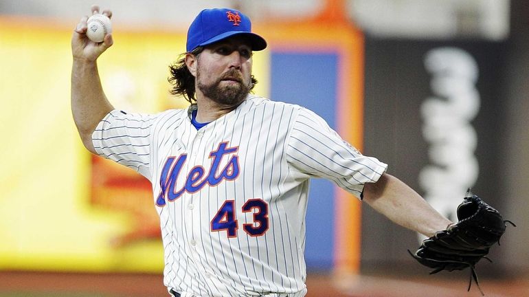 R.A. Dickey delivers a pitch during the first inning against...